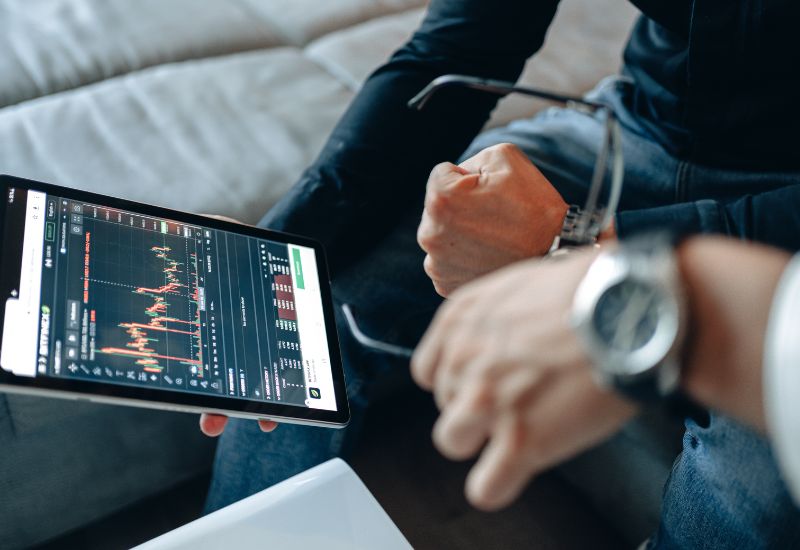Investor in Front of Tablet with Crypto Trading Graphic
