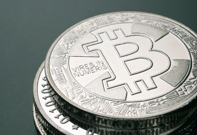 Plated Bitcoins above green background